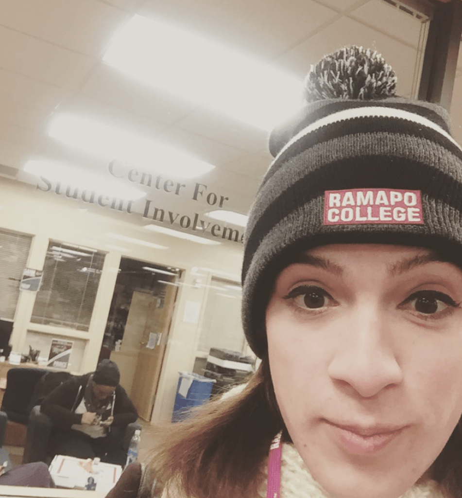 Arielle in front of Ramapo's Center for Student Involvement, wearing a Ramapo College beanie.