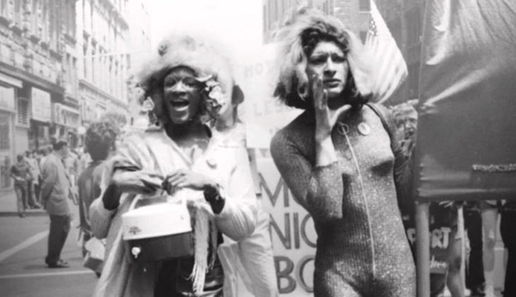 Marsha P Johnson, a black transgender woman, and Sylvia Rivera, a latinx trans woman, march in the Christopher Street Liberation Day Parade (the predecessor to Pride).