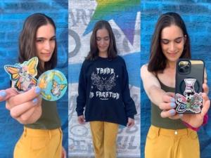 A person wearing a sweater and holding some stickers.